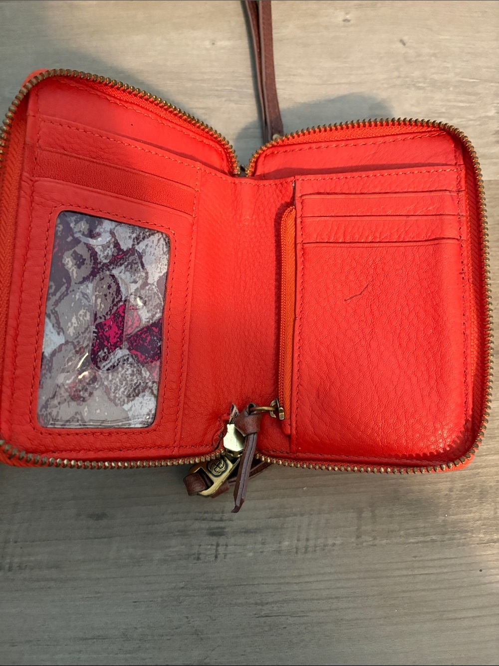 orange leather Elliott Lucca wristlet features a hand-painted peacock feather - Picture 5 of 8